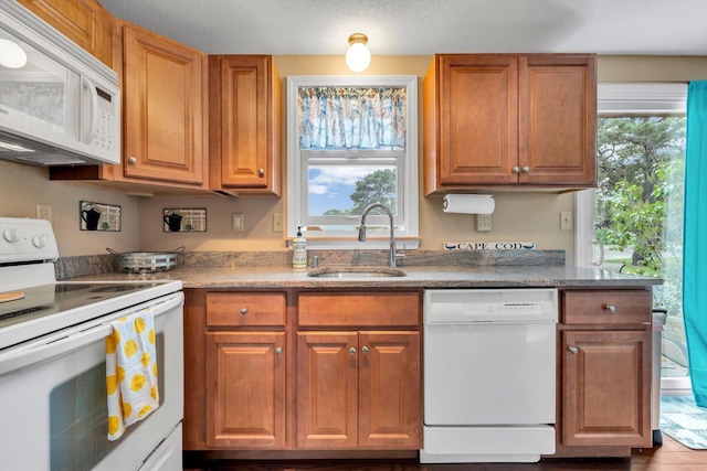 111 School St Unit 6, West Dennis, MA 02670 - kitchen featuring white appliances, brown cabinets, and stone countertops
