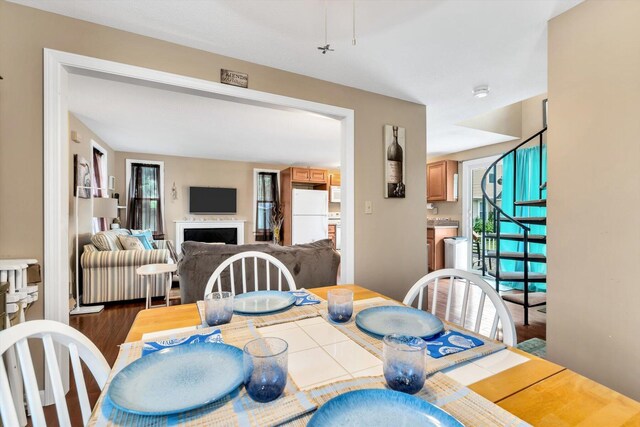 111 School St Unit 6, West Dennis, MA 02670 - dining space featuring plenty of natural light, a fireplace, and wood finished floors