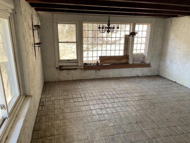 15 Cabral Farm Rd, Truro, MA 02666 - unfurnished dining area featuring brick floor, an inviting chandelier, and plenty of natural light