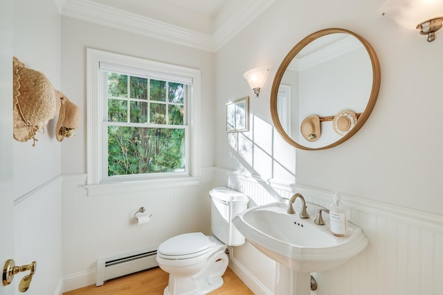 bathroom featuring hardwood / wood-style flooring, toilet, a healthy amount of sunlight, and baseboard heating