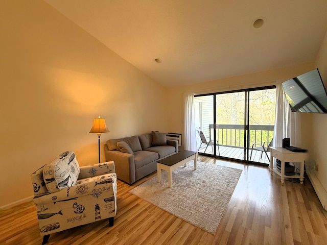 living room with lofted ceiling and wood finished floors