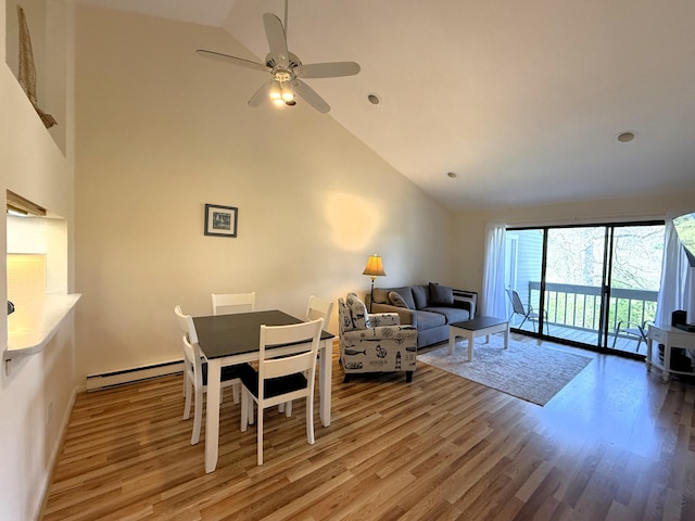 living room with wood finished floors, baseboard heating, high vaulted ceiling, a ceiling fan, and recessed lighting