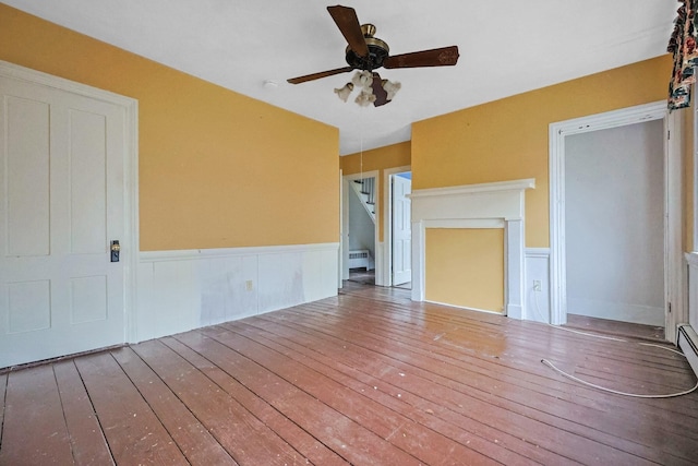 32 Church St, Sandwich, MA 02563 - unfurnished living room with hardwood / wood-style flooring, a wainscoted wall, ceiling fan, and stairway