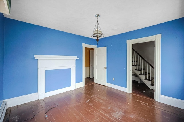 32 Church St, Sandwich, MA 02563 - unfurnished living room with wood-type flooring, stairway, and a baseboard radiator