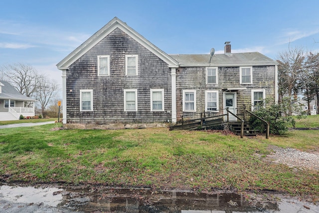 32 Church St, Sandwich, MA 02563 - view of front of home with a chimney and a front lawn