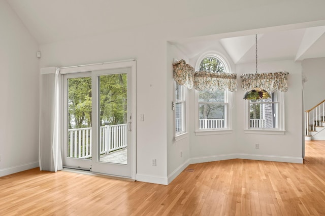 47 Cove View Dr, South Yarmouth, MA 02664 - unfurnished dining area with lofted ceiling, light wood-style floors, healthy amount of natural light, and stairs