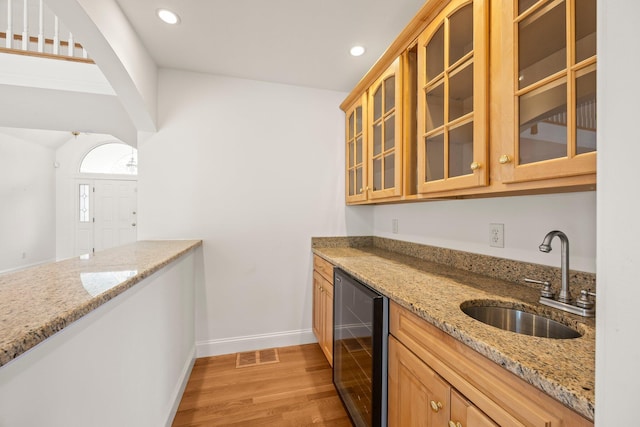 47 Cove View Dr, South Yarmouth, MA 02664 - kitchen featuring beverage cooler, a sink, light wood-style flooring, light stone countertops, and recessed lighting