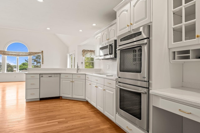 47 Cove View Dr, South Yarmouth, MA 02664 - kitchen featuring stainless steel appliances, light wood-style floors, white cabinets, recessed lighting, and vaulted ceiling