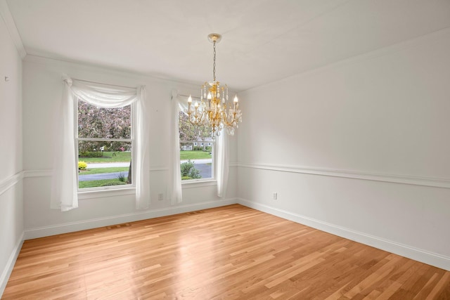 47 Cove View Dr, South Yarmouth, MA 02664 - spare room featuring a chandelier, light wood-style flooring, baseboards, and ornamental molding