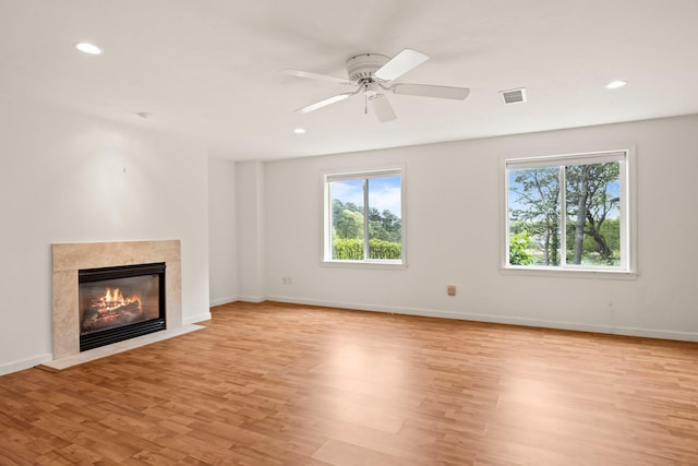 47 Cove View Dr, South Yarmouth, MA 02664 - unfurnished living room with healthy amount of natural light, light wood-style flooring, a high end fireplace, recessed lighting, and baseboards