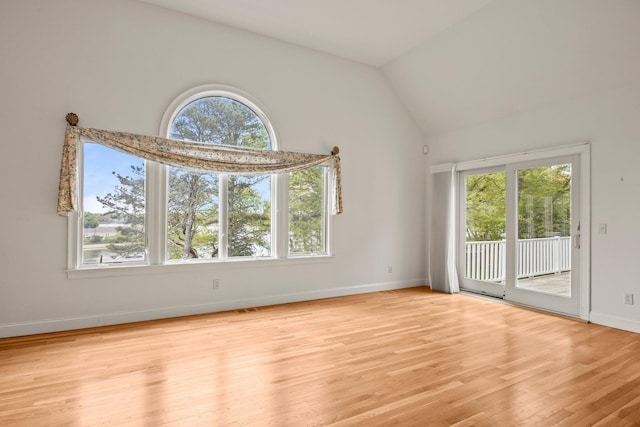 47 Cove View Dr, South Yarmouth, MA 02664 - empty room with plenty of natural light, vaulted ceiling, light wood-style floors, and baseboards
