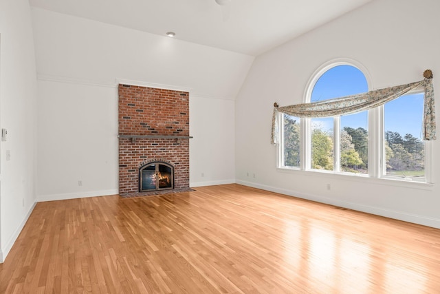47 Cove View Dr, South Yarmouth, MA 02664 - unfurnished living room featuring lofted ceiling, plenty of natural light, light wood finished floors, and baseboards