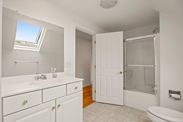 47 Cove View Dr, South Yarmouth, MA 02664 - bathroom featuring a skylight, combined bath / shower with glass door, vanity, and toilet