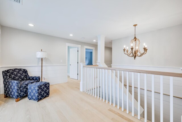 living area with hardwood / wood-style floors and an inviting chandelier