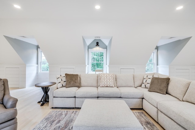 living room with vaulted ceiling and light hardwood / wood-style floors