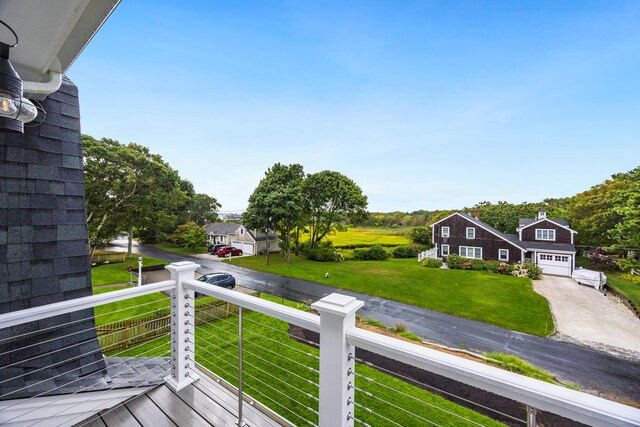 wooden deck with a lawn