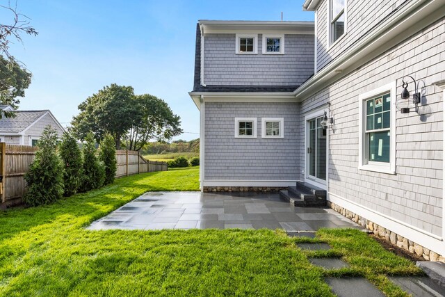 rear view of property with a patio area and a lawn