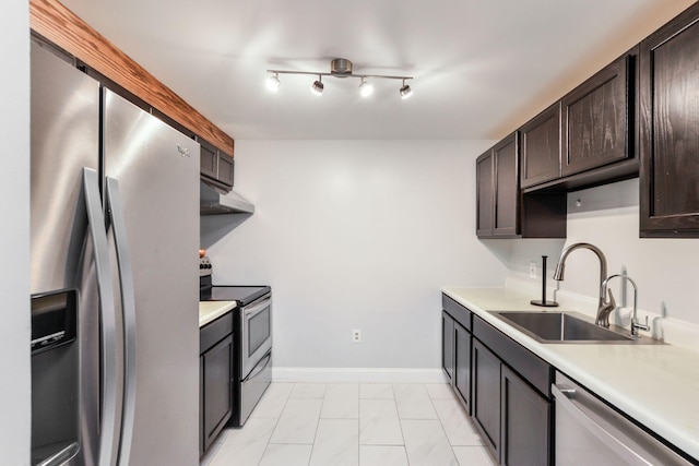 2 Marc Dr Unit 2B2, Plymouth, MA 02360 - kitchen with dark brown cabinetry, appliances with stainless steel finishes, under cabinet range hood, light countertops, and a sink