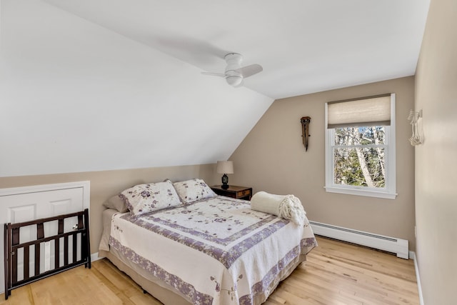 51 Buccaneer Way, Mashpee, MA 02649 - bedroom featuring baseboard heating, light wood-type flooring, lofted ceiling, a ceiling fan, and baseboards