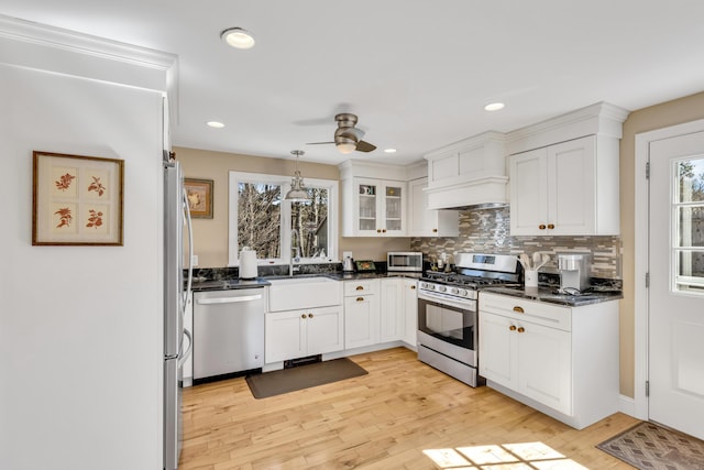 51 Buccaneer Way, Mashpee, MA 02649 - kitchen with appliances with stainless steel finishes, a ceiling fan, custom range hood, white cabinetry, and light wood-style flooring