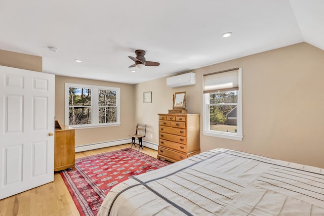 51 Buccaneer Way, Mashpee, MA 02649 - bedroom with a baseboard heating unit, an AC wall unit, light wood-type flooring, ceiling fan, and recessed lighting