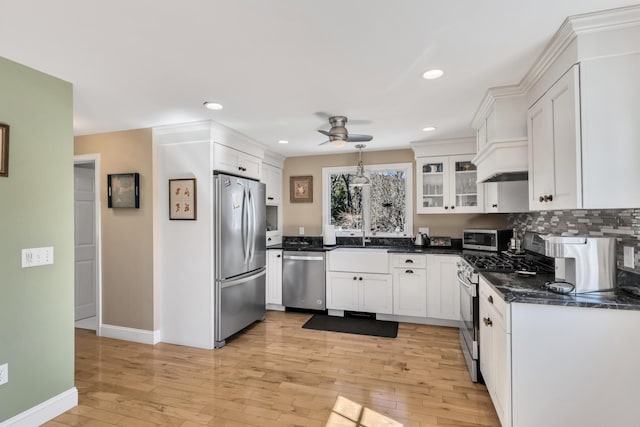 51 Buccaneer Way, Mashpee, MA 02649 - kitchen featuring stainless steel appliances, a ceiling fan, baseboards, light wood-type flooring, and white cabinetry