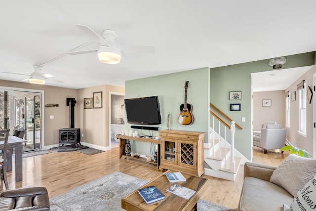 51 Buccaneer Way, Mashpee, MA 02649 - living area with ceiling fan, wood finished floors, stairway, a wood stove, and baseboards