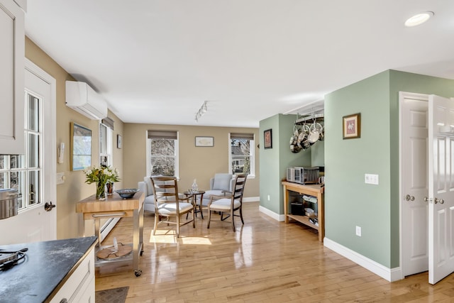 51 Buccaneer Way, Mashpee, MA 02649 - dining space with a wall mounted air conditioner, light wood finished floors, a baseboard radiator, and baseboards