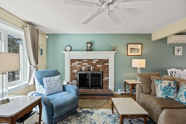 living room with a fireplace, wood finished floors, a baseboard radiator, and a ceiling fan