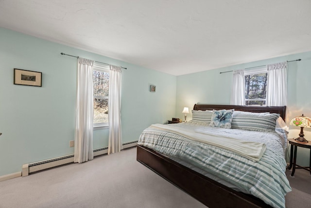 bedroom with baseboard heating and light colored carpet