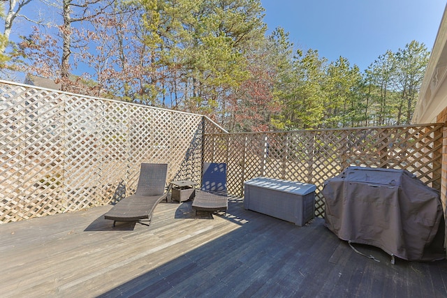 wooden deck featuring a grill