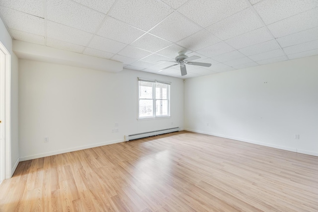 105 Edgewater Dr W, East Falmouth, MA 02536 - spare room with baseboard heating, ceiling fan, a drop ceiling, light wood-style flooring, and baseboards
