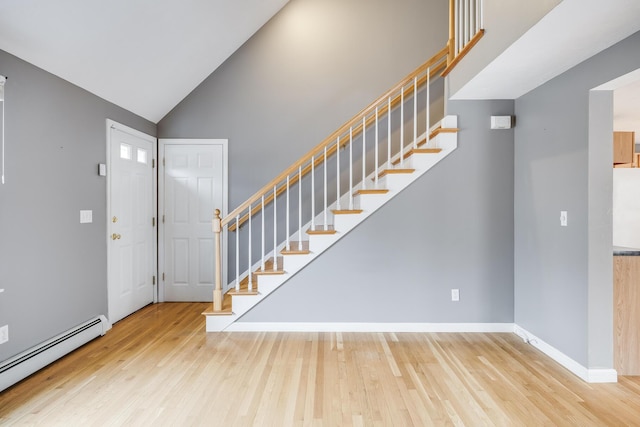 105 Edgewater Dr W, East Falmouth, MA 02536 - entryway featuring baseboard heating, wood finished floors, stairs, high vaulted ceiling, and baseboards
