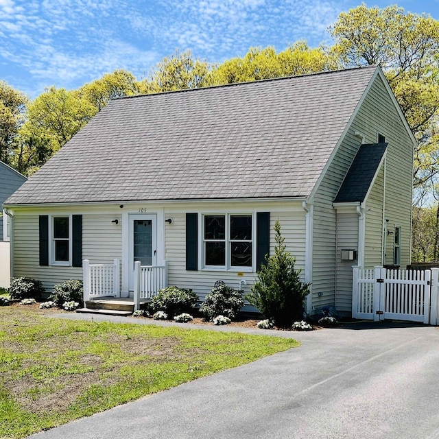 105 Edgewater Dr W, East Falmouth, MA 02536 - cape cod-style house featuring a gate and roof with shingles