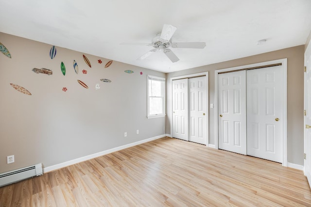 105 Edgewater Dr W, East Falmouth, MA 02536 - unfurnished bedroom featuring a baseboard heating unit, two closets, and light wood finished floors