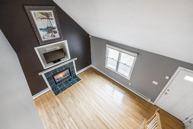 105 Edgewater Dr W, East Falmouth, MA 02536 - unfurnished living room with wood finished floors, a fireplace, baseboards, and lofted ceiling