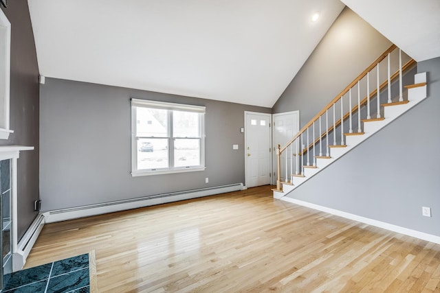 105 Edgewater Dr W, East Falmouth, MA 02536 - foyer with a baseboard heating unit, stairs, wood finished floors, and high vaulted ceiling