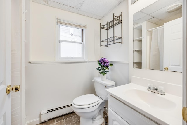 105 Edgewater Dr W, East Falmouth, MA 02536 - bathroom featuring a baseboard heating unit, a paneled ceiling, toilet, vanity, and baseboards