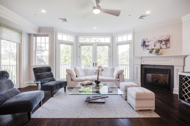 66 Simons Rd Unit C, Mashpee, MA 02649 - living area featuring crown molding, plenty of natural light, a ceiling fan, a glass covered fireplace, and wood finished floors