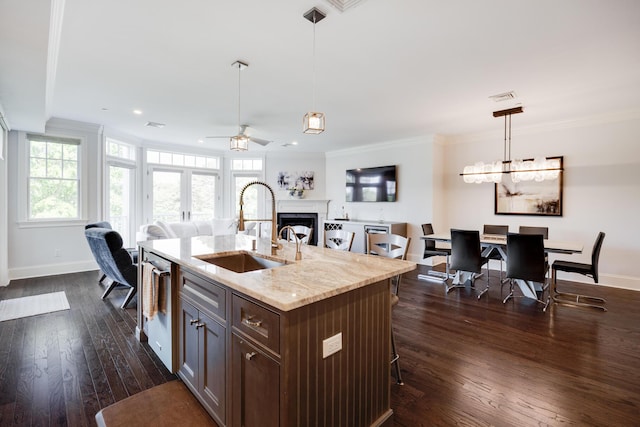 66 Simons Rd Unit C, Mashpee, MA 02649 - kitchen with ceiling fan, open floor plan, dark wood-type flooring, a breakfast bar area, and ornamental molding