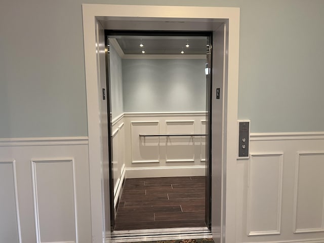 66 Simons Rd Unit C, Mashpee, MA 02649 - elevator with a decorative wall, wood finished floors, ornamental molding, and wainscoting