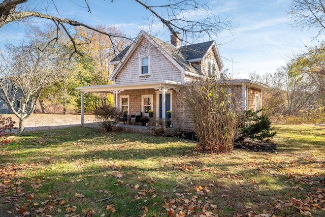 view of front facade with a front yard and covered porch