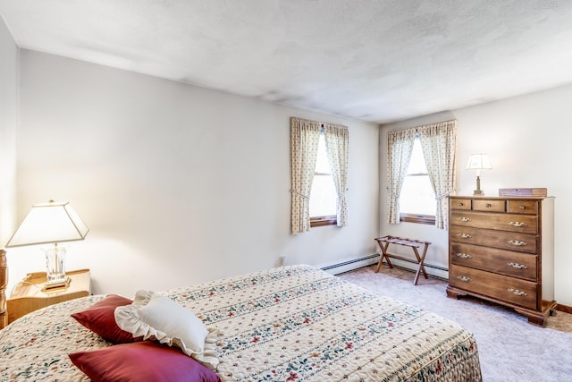 bedroom with light carpet, baseboard heating, and baseboards