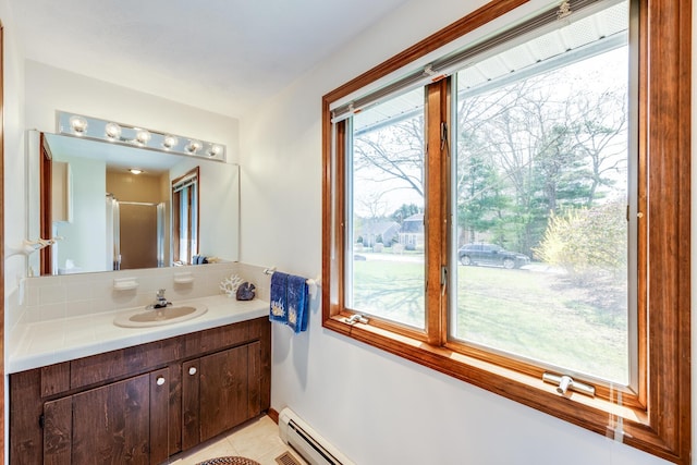 bathroom featuring vanity, tile patterned floors, and baseboards