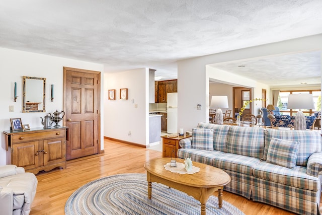 living room featuring light wood-type flooring and baseboards