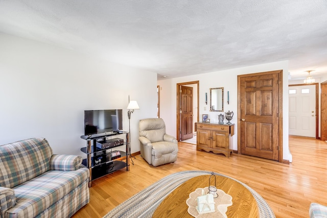 living area featuring light wood finished floors and baseboards