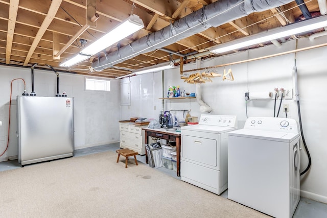 clothes washing area with washer and clothes dryer