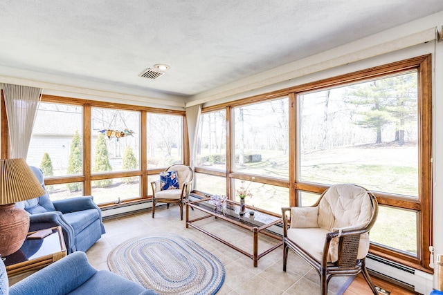living room featuring a baseboard heating unit, light tile patterned flooring, baseboard heating, and plenty of natural light
