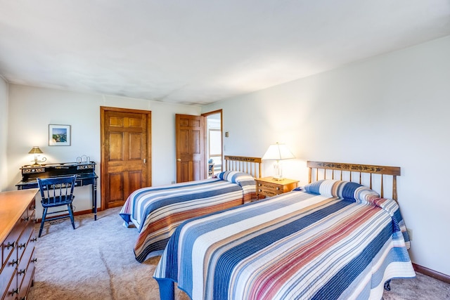 carpeted bedroom with baseboards