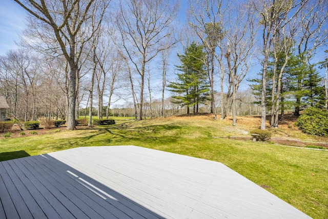 wooden terrace with a lawn